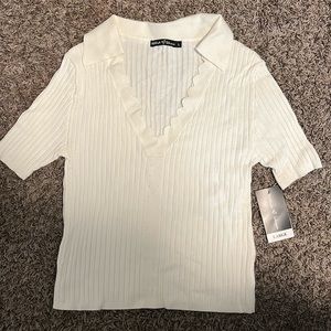 V-Necked Sweater - Size Large sweater has flowery detail on neckline.